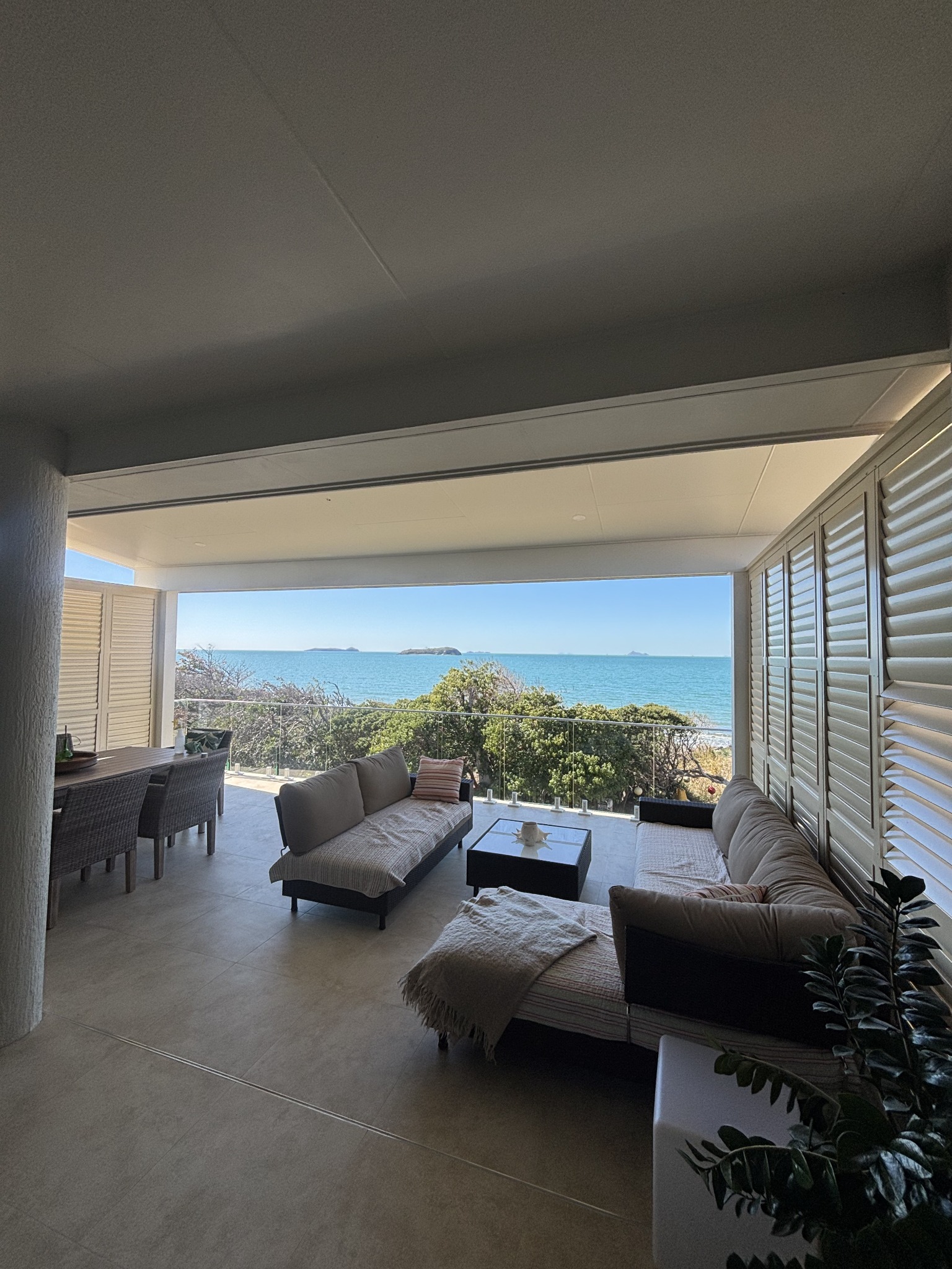 Covered coastal outdoor living space overlooking the ocean