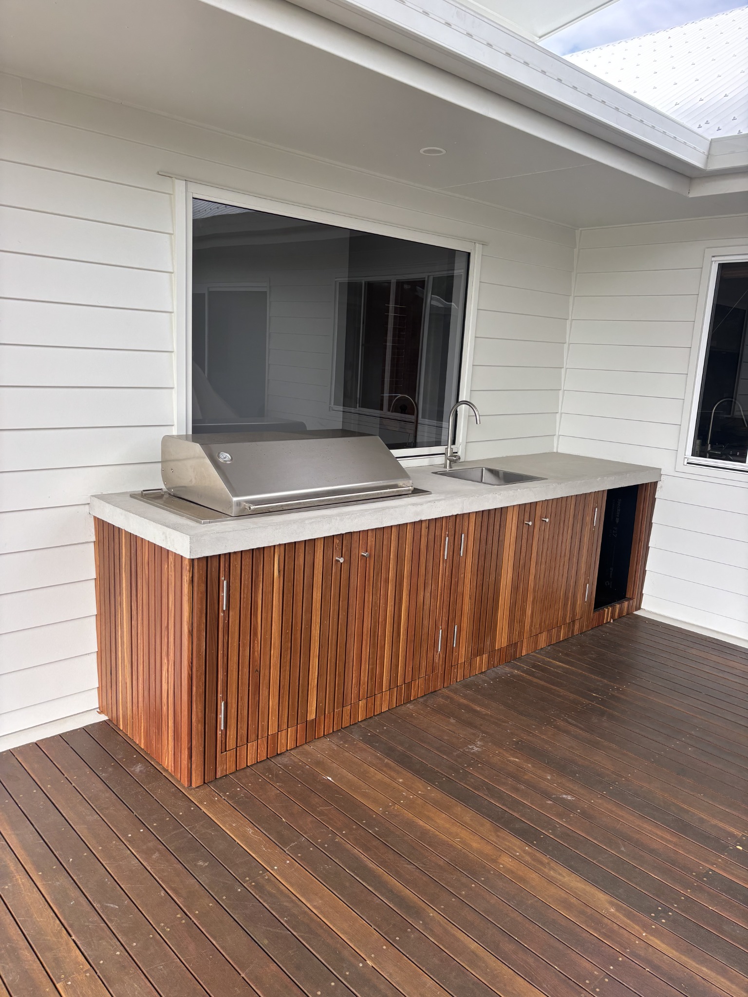 Outdoor kitchen with timber cabinetry and benchtop