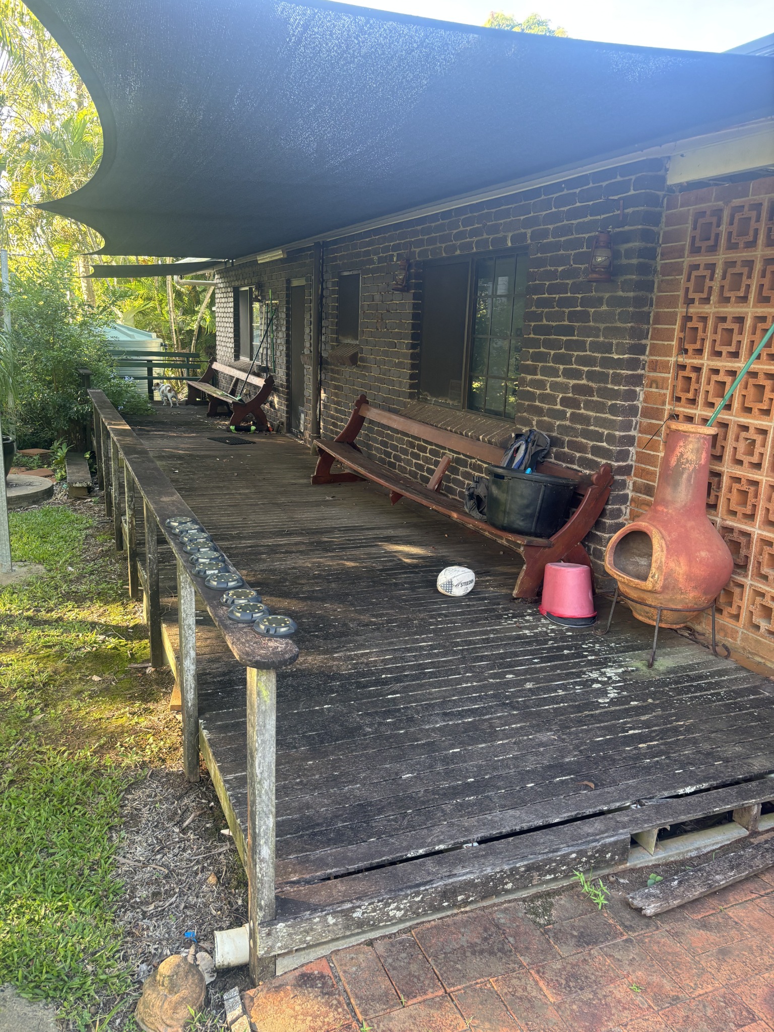 Before — weathered timber deck
