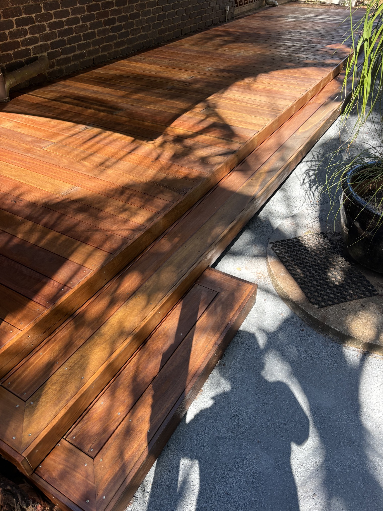 Finished timber decking with rich colour and neatly detailed steps